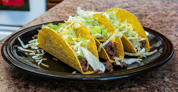 Handmade hard shell ground beef, lettuce and cheese taco