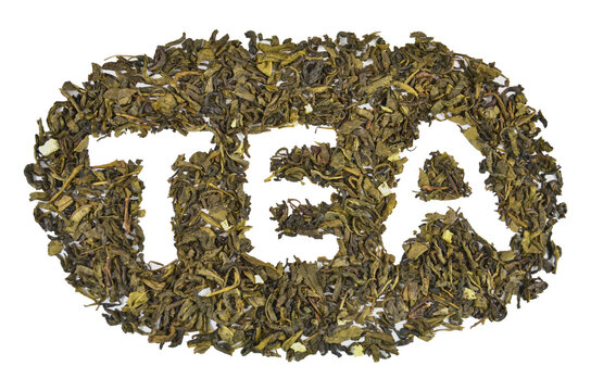 Dry green leaf tea shaped into inscription (text) "TEA", closeup (macro), top view