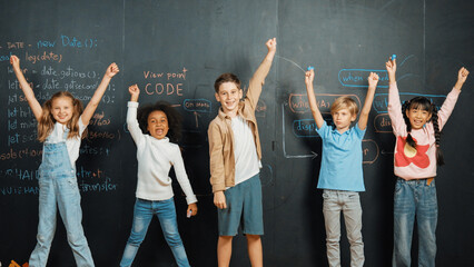 Diverse student raised hands up while standing at blackboard written with engineering prompt or...