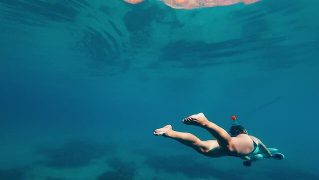Woman using underwater scooter for diving. Modern sea scooter, modern technology concept.
