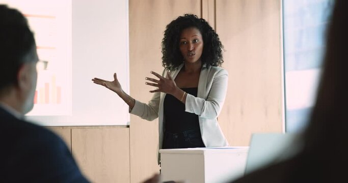 Professional African businesswoman make speech during financial congress. Business people gathered together to discuss various topics related to finances, economics, investment and banking. Seminar