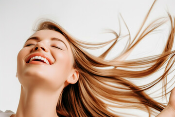 A woman with long, flowing hair is smiling with her eyes closed