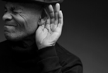deaf man suffering from deafness and hearing loss on grey background with people stock photo	