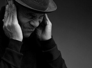 deaf man suffering from deafness and hearing loss on grey background with people stock photo	