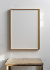A rectangular picture frame hangs on the wall above a wooden table in a room with hardwood shelving. The room also features plywood shelves and a computer monitor accessory