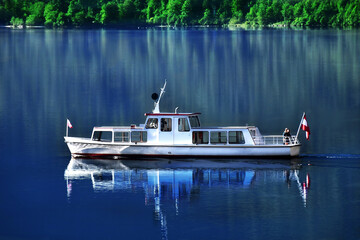 A white ship sailing on the lake