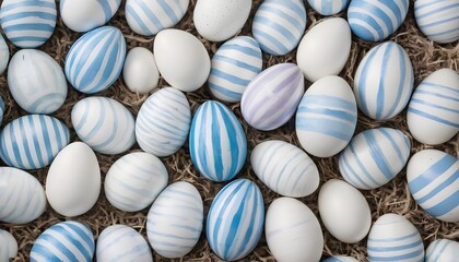 Blue and white stripes colored easter eggs in a wicker nest - obrazy, fototapety, plakaty