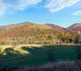 Autumn Carpathian Mountains landscape with evening shadow on field (Ivano-Frankivsk oblast, Ukraine). Rural scene.