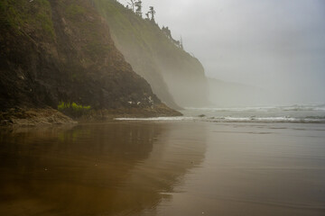 Dark Cliffs Reflect In The Wet Sand Of Cape Lookout