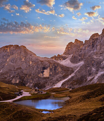 Evening twilight autumn alpine Dolomites mountain scene, Trento, Italy. Lake or Laghetto Baita Segantini view.