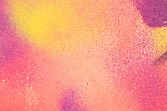 Part of colorful wall with graffiti spray strokes. Pink, purple, yellow color splash, flows, streaks of paint and paint sprays