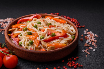 Delicious rice noodles or udon with chicken, carrots, pepper, salt, spices and herbs