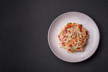Delicious rice noodles or udon with chicken, carrots, pepper, salt, spices and herbs