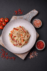 Delicious rice noodles or udon with chicken, carrots, pepper, salt, spices and herbs