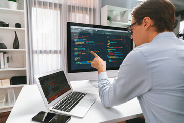 IT developer selecting by point on coding online software development information on pc comparing...