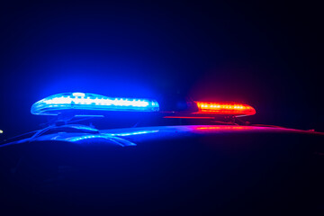 Red and blue lights of a police car at night close up. stock photo