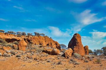 Red laterite rock formations and drought resistant vegetation in the Australian outback, in the vicinity of Mount Magnet, Western Australia.
