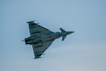 military fighter plane, turning in the sky