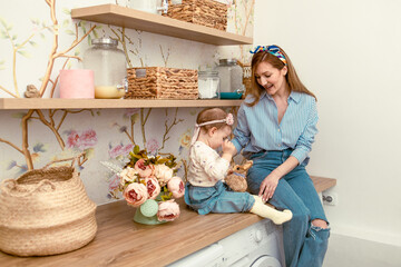 Mom showing her daughter bunny toy. Eastern