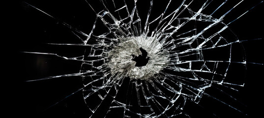 Bullet hole in glass isolated on black