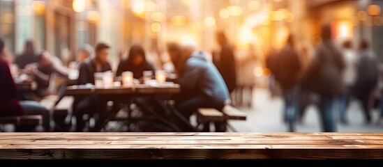 A crowd of people is gathered around a wooden table in a city restaurant, enjoying the entertainment in the room. The buildings heat adds to the lively atmosphere of the event - obrazy, fototapety, plakaty