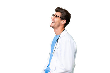 Young doctor man over isolated background laughing in lateral position