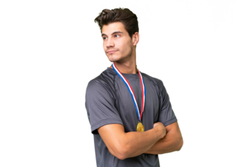 Young caucasian man with medals over isolated background in lateral position