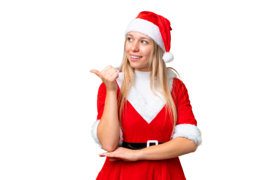 Young blonde woman with christmas hat over isolated chroma key background pointing to the side to present a product