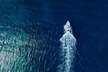Vacation and leisure. Aerial view on fast boat on blue sea at sunny day. Fast ship on the sea surface. Seascape from the drone. Seascape from air. Seascape with motorboat. - 760080279