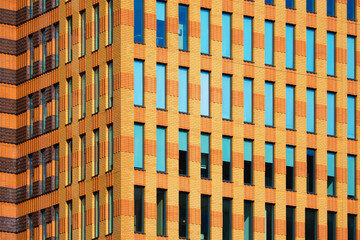 A lot of windows on a skyscraper building. Urban textures and backgrounds. Modern architecture and design. Building details. - 760081268