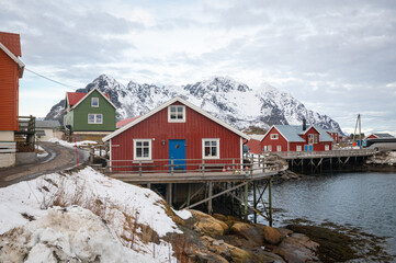 Traditional red norwegian houses in the fishing village of Henningsvær on Lofoten islands,...