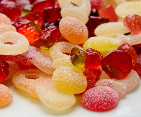 Lots of colorful candies made of jelly and various fruits, background and texture	