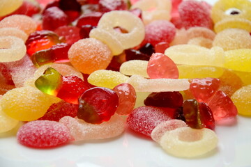 Lots of colorful candies made of jelly and various fruits, background and texture