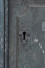 Keyhole metal on an old dark shabby vintage european door in the ancient city, vintage style, antique