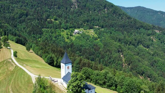 Aerial morning view of St. Primoz church at Jamnik, Slovenia, Julian alps.