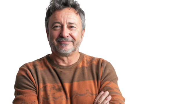 A man with his arms crossed standing confidently against a white backdrop