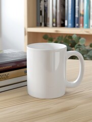 A blank white mug on table with books under it.