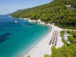 White sandy beach with blue ocean lagoon and yacht moored. Skopelos island, Kastani beach, Sporades, Greece © barmalei