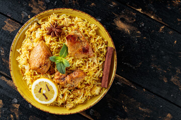 Chicken Biryani with Basmati Rice on Dark Wooden Boards, Copy Space, Top View