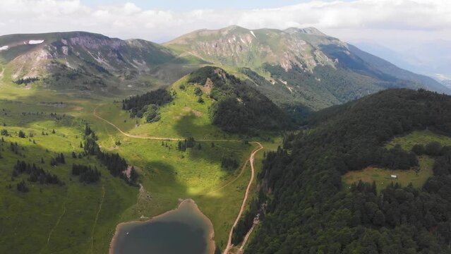 Aerial scenic green mountain and lake in Biogradska Gora National Park. Hiking, travel destinations in Montenegro, adventure concept, flying along mountain ridge. High quality 4k footage