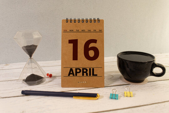 April 16th. Wooden cubes with date of 16 April on old blue wooden background.