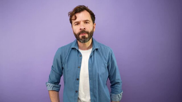 Furious man trying to control his anger in a studio