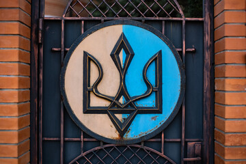 The symbol of the national coat of arms of Ukraine on the metal entrance doors to private property. Kyiv. Ukraine.