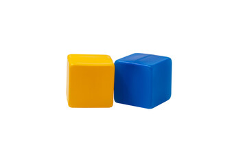 Multicoloured plastic cubes for children's games. Yellow and blue cubes are lying side by side. No background. One next to the other. Horizontally. High quality photo.