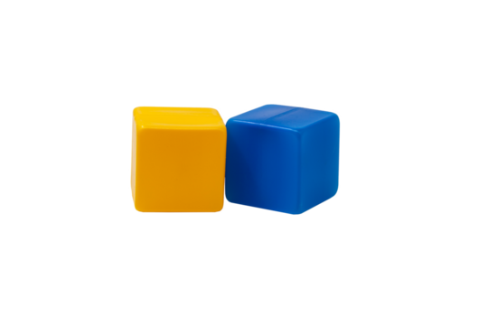 Multicoloured plastic cubes for children's games. Yellow and blue cubes are lying side by side. No background. One next to the other. Horizontally. High quality photo.