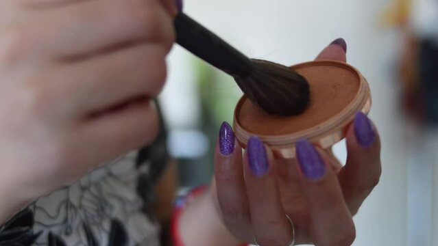 closeup of a hand taking off makeup
