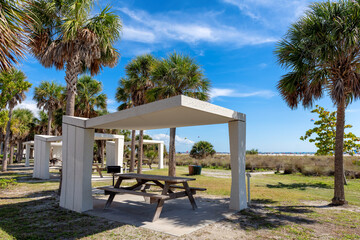 Picnic tables and shelters at the Siesta Key Beach in Florida, where visitors can enjoy a picnic under palm trees in ocean beach. - 760173069