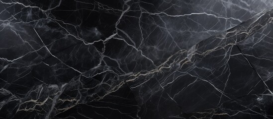 A close up shot of a monochrome black marble texture featuring white veins, resembling a striking...