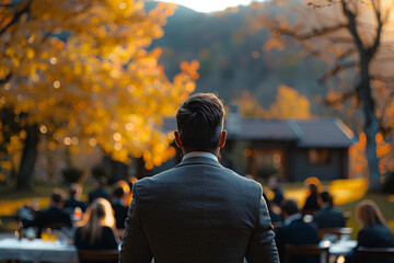A businessman leading a corporate retreat in a serene countryside retreat center. - obrazy, fototapety, plakaty