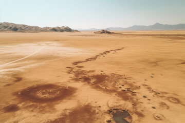Fototapeta na wymiar Arid Desert Aerial, Drone View of Dry Pond with Scant Water